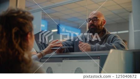 Man Giving Documents and Airplane Ticket, Verifying Biometric Data by Scanning Fingerprint 125040672