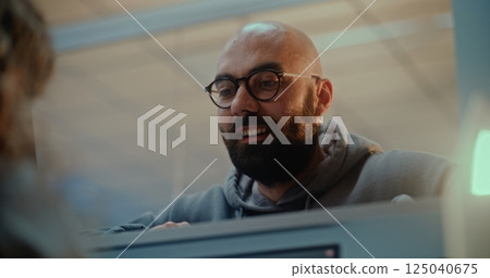 Airport Check-in Counter: Close Up of Man Talking to Airline Agent During Passport Check 125040675
