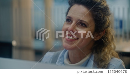 Close Up of Female Airline Worker Checking Documents and Airplane Ticket of Passenger 125040678