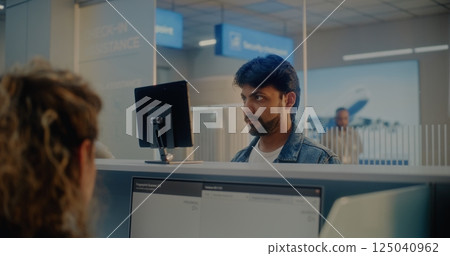 Airport Check-in Counter: Indian Man Giving Documents, Verifying by Facial Recognition Scanning 125040962