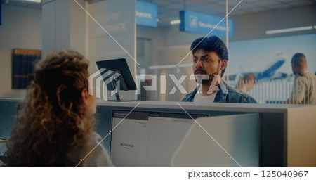 Check-in Counter: Indian Man Giving Documents to Airline Agent, Scanning Fingerprint 125040967