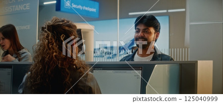 Airport Check-in Counter: Indian Man Verifying Personal ID Data by Facial Recognition Scanning 125040999