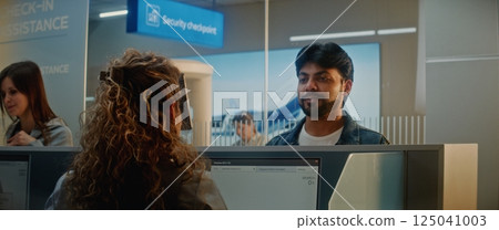 Airport Check-in Counter: Indian Man Verifying Personal ID Data by Facial Recognition Scanning Airport Check-in Counter: Indian Man Verifying Personal ID Data by Facial Recognition Scanning 125041003