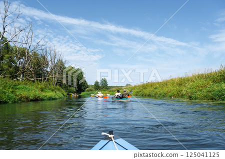 Group kayak trip for seigneur and senora. An elderly couple And adult rowing boat on the river, a water hike, a summer adventure. Age-related sports, mental youth and health, tourism, active old age Group kayak trip for seigneur and senora. An elderly couple And adult rowing boat on the river, a water hike, a summer adventure. Age-related sports, mental youth and health, tourism, active old age 125041125