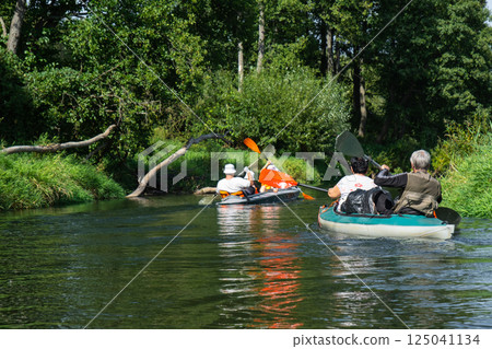 Group kayak trip for seigneur and senora. An elderly couple And adult rowing boat on the river, a water hike, a summer adventure. Age-related sports, mental youth and health, tourism, active old age 125041134