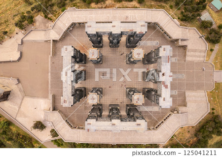 Aerial top view to Chronicle of Georgia with Tbilisi Sea lake in background. Sightseeing Monument of History. Famous important culture memorial Georgian Stonehenge, Sakartvelo, Caucasus, Europe. 125041211