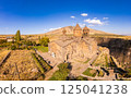 Aerial top view of Saghmosavank Monastery 13h centuries is located huge gorge canyon of Kasakh River. Church and Mount Ara on beckground in sunny summer day. Saghmosavan, Aragatsotn, Armenia, Europe 125041238