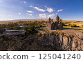 Aerial top view of Saghmosavank Monastery 13h centuries is located huge gorge canyon of Kasakh River. Church and Mount Ara on beckground in sunny summer day. Saghmosavan, Aragatsotn, Armenia, Europe 125041240