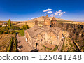 Aerial top view of Saghmosavank Monastery 13h centuries is located huge gorge canyon of Kasakh River. Church and Mount Ara on beckground in sunny summer day. Saghmosavan, Aragatsotn, Armenia, Europe 125041248