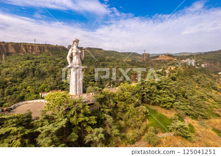 Aerial panoramic view of statue of Mother of Georgia Kartlis Deda by georgian sculptor Elguja Amashukeli from drone. Monument overlooking Tbilisi City from Sololaki Hill. Erected in 1958. Europe. Aerial panoramic view of statue of Mother of Georgia Kartlis Deda by georgian sculptor Elguja Amashukeli from drone. Monument overlooking Tbilisi City from Sololaki Hill. Erected in 1958. Europe. 125041251