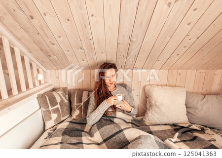Happy Woman Drinking Morning Coffee in Bed Happy Woman Drinking Morning Coffee in Bed 125041363