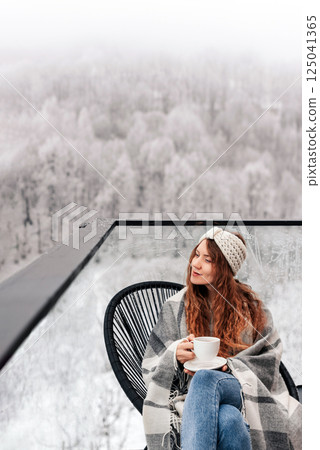 Woman Drinking Tea on House Terrace in Winter Woman Drinking Tea on House Terrace in Winter 125041365
