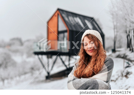 Happy Woman Enjoying Winter Holidays in Log Cabin 125041374