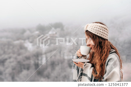 Woman Drinking Morning Coffee on Winter Terrace Woman Drinking Morning Coffee on Winter Terrace 125041377