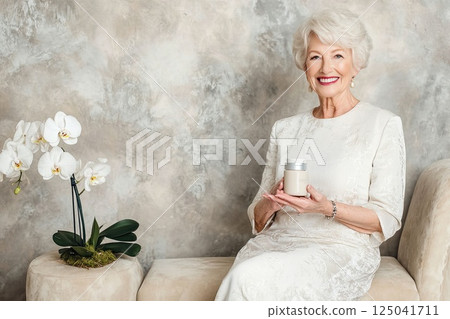 Elderly woman enjoys spa time while using cream and smiling in a serene environment with orchids Elderly woman enjoys spa time while using cream and smiling in a serene environment with orchids 125041711