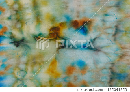 abstract pattern on silk fabric texture in blue, yellow, green colors 125041853