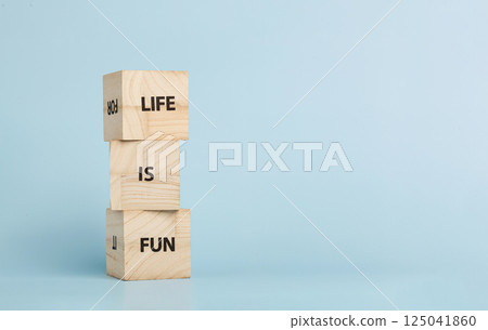 Wooden cubes with inscriptions Let Is Fun on a blue background 125041860