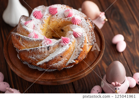 Traditional Easter cakes with icing decorated candies on dark wooden table 125041961