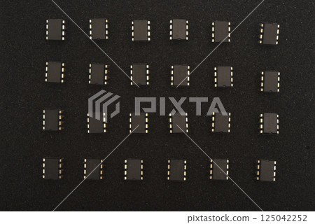 Microcircuits on black foam. Multiple chips on a substrate. 125042252