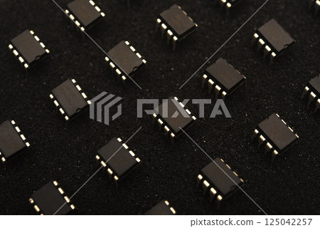 Microcircuits on black foam. Multiple chips on a substrate. 125042257