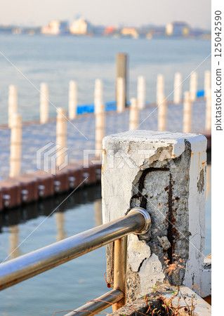 Cracked grey concrete surface with visible reinforcement, Rust in reinforcement of Concrete bridge, Broken or weak concrete. 125042590