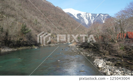 River Valley Japan Spring: Mountain stream scenic view during springtime showcasing nature's beauty. 125043004