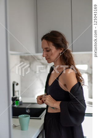 Woman Kitchen Morning Routine: Home Coffee Preparation, Relaxation, Clothing 125043169