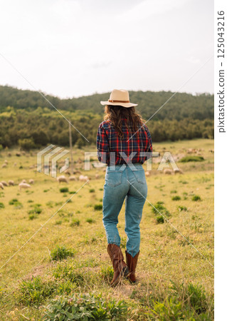 A woman wearing a plaid shirt 125043216