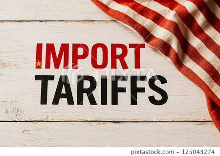 IMPORT TARIFFS painted on wood with red and white fabric symbolizing economic restrictions, protectionist trade measures and taxation policies 125043274