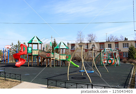 Russia, Saint Petersburg, April 14, 2025. Children's playground with various play structures in a village in Russia, Leningrad region. Play structures of houses for sports development of children. Russia, Saint Petersburg, April 14, 2025. Children's playground with various play structures in a village in Russia, Leningrad region. Play structures of houses for sports development of children. 125043403