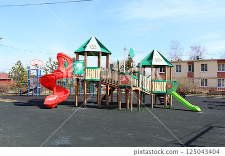 Russia, Saint Petersburg, April 14, 2025. Children's playground with various play structures in a village in Russia, Leningrad region. Play structures of houses for sports development of children. Russia, Saint Petersburg, April 14, 2025. Children's playground with various play structures in a village in Russia, Leningrad region. Play structures of houses for sports development of children. 125043404