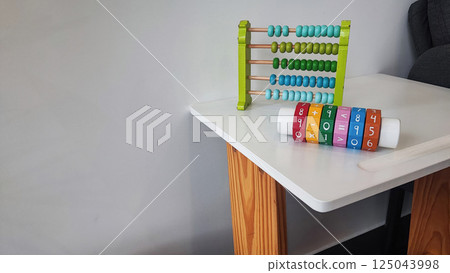 Children's wooden construction set, abacus, on a white table. Concept of children's development, montesori 125043998