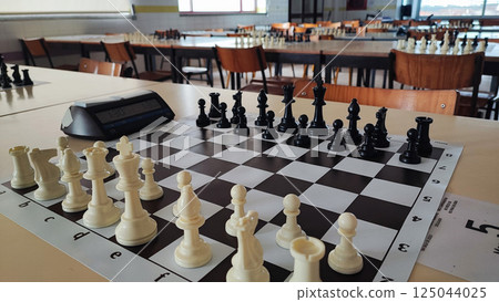 A chessboard with pieces prepared for a tournament. Concept of chess competitions, tournaments, A chessboard with pieces prepared for a tournament. Concept of chess competitions, tournaments, 125044025