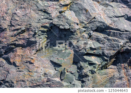 Angular fractured metamorphic rock, sharp edges, natural texture, outdoor, daylight 125044643