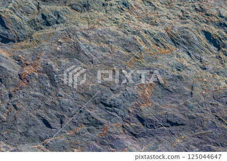 Wavy foliated metamorphic rock, irregular texture, natural surface, outdoor, daylight Wavy foliated metamorphic rock, irregular texture, natural surface, outdoor, daylight 125044647