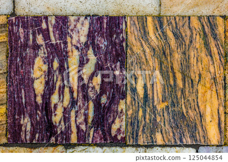 Worn Marble Floor Tiles with Striking Purple and Gold Veins Worn Marble Floor Tiles with Striking Purple and Gold Veins 125044854