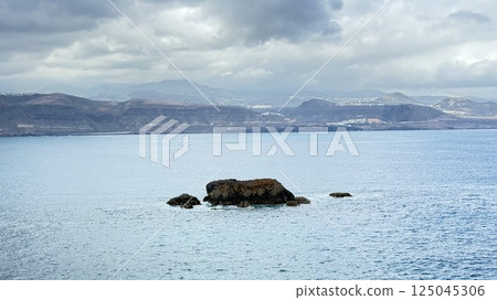 the beach rock in the middle of the ocean stands alone 125045306