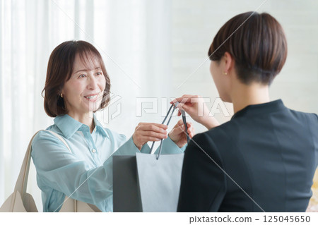 Staff handing over luggage to customers Staff handing over luggage to customers 125045650