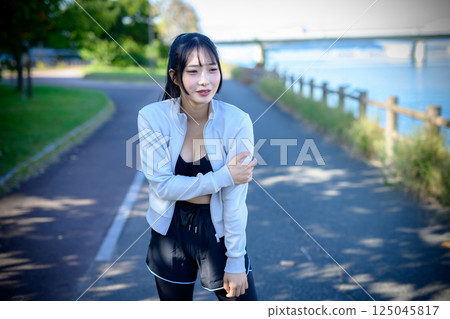 Young woman hurting her arm while exercising, injury, danger, problem, diet, walking, stroll Young woman hurting her arm while exercising, injury, danger, problem, diet, walking, stroll 125045817