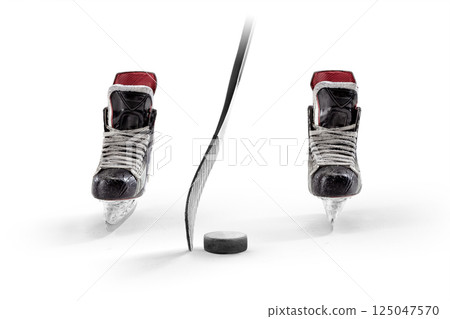 Hockey. Professional equipment in white background. Sport. Hockey skates, stick and puck close-up. Front view. Hockey equipment Hockey. Professional equipment in white background. Sport. Hockey skates, stick and puck close-up. Front view. Hockey equipment 125047570