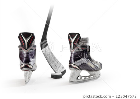 Hockey skates, stick and puck close-up. Rear view. Hockey. Professional equipment in white background. Sport. Hockey equipment 125047572