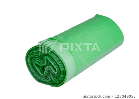 Garbage bags in a roll, green color, isolate. Recycled material, garbage bag on a white background. 125049055