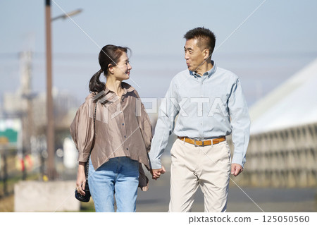Middle-aged couple taking a walk 125050560