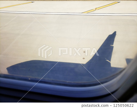 Shadow of a Passenger Jet Landing on a Runway 125050622