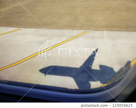 Shadow of a Passenger Jet Landing on a Runway Shadow of a Passenger Jet Landing on a Runway 125050625