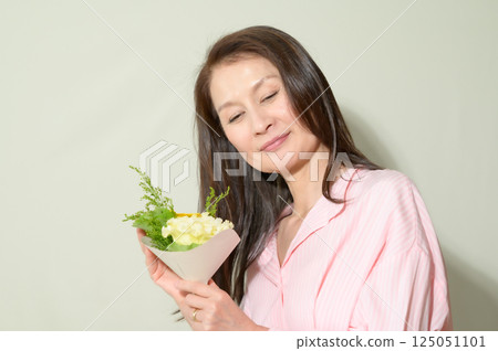 Senior woman holding flowers Senior woman holding flowers 125051101