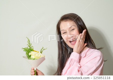 Senior woman holding flowers Senior woman holding flowers 125051118