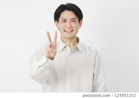Man in his 20s, peace sign, white background 125051252