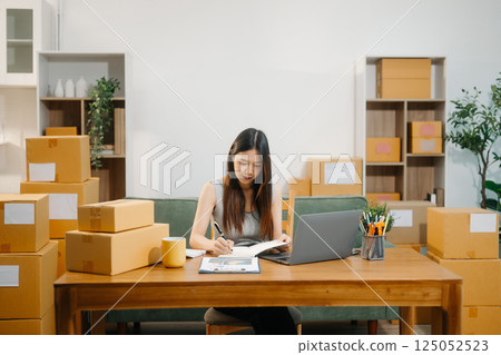 Startup small business SME, Entrepreneur owner woman using smartphone or tablet taking receive Startup small business SME, Entrepreneur owner woman using smartphone or tablet taking receive 125052523