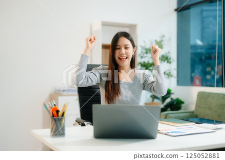 Young attractive Asian woman smiling thinking planning writing in notebook, tablet and laptop working from home Young attractive Asian woman smiling thinking planning writing in notebook, tablet and laptop working from home 125052881